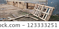Wood house demolition or disaster with wooden boards 123333251