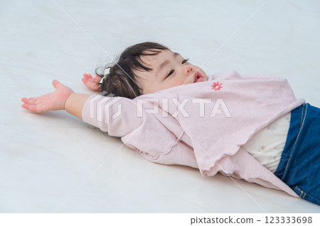 [Infants and toddlers lying down on giant playground equipment] 123333698