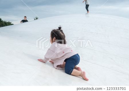 [Infants crawling on giant playground equipment] 123333701