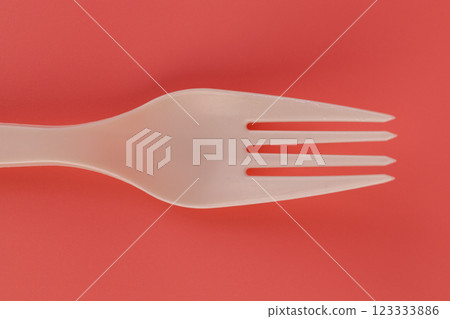close up soft pink background pair of plastic white forks disposable tableware eco technology reusable care for the planet picnic set 123333886