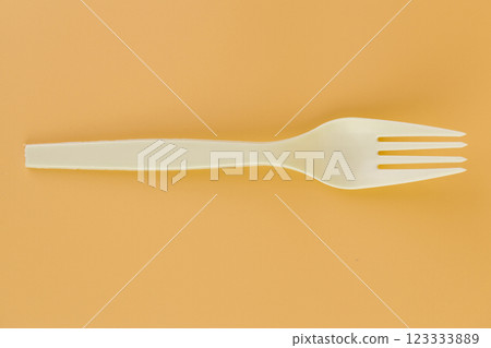 soft yellow background pair of plastic white forks disposable tableware eco technology reusable care for the planet picnic set 123333889