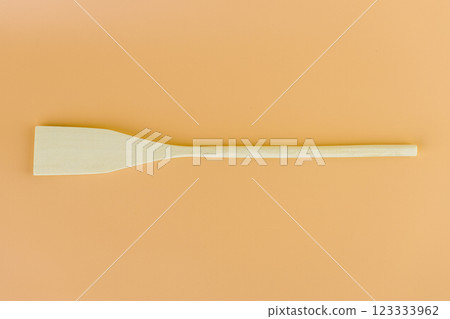 close-up on soft yellow background lie new kitchen light wooden utensils forms spoons spatulas for teflon coating natural wood handmade different types of use 123333962