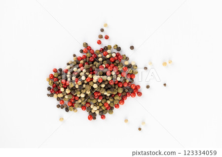 on white background a pile of mixed large aromatic peppers black red and white the main seasoning for food peppercorns indian and european spices the best variety on white background a pile of mixed large aromatic peppers black red and white the main seasoning for food peppercorns indian and european spices the best variety 123334059