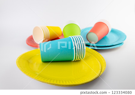top shot on white background there are three paper cups yellow red and blue with matching paper plates set disposable tableware standard picnic set top shot on white background there are three paper cups yellow red and blue with matching paper plates set disposable tableware standard picnic set 123334080
