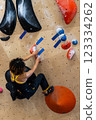 fit woman exercising on climbing wall in gym 123334262
