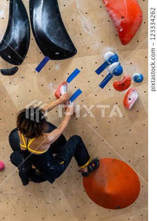 fit woman exercising on climbing wall in gym fit woman exercising on climbing wall in gym 123334262