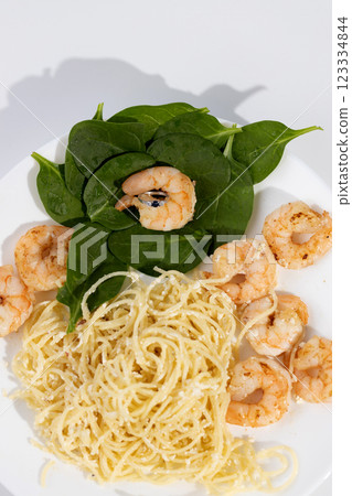 on a white plate lies italian pasta with shrimps on sprat leaves one shrimp in which is an engagement ring with blue stone natural sapphire marriage proposal 123334844
