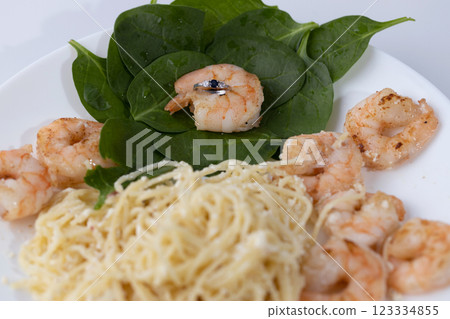 on a white plate lies italian pasta with shrimps on sprat leaves one shrimp in which is an engagement ring with blue stone natural sapphire marriage proposal on a white plate lies italian pasta with shrimps on sprat leaves one shrimp in which is an engagement ring with blue stone natural sapphire marriage proposal 123334855