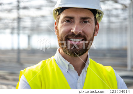 Portrait picture of a young caucasian engineer in a protective helmet 123334914