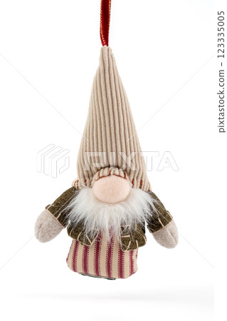 close-up on white background hanging textile soft Christmas tree toy in the form of a forest gnome with a large cap pastel colors modern decor 123335005