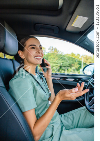 Female doctor in lab suit with a phone in hand talking to the patient Female doctor in lab suit with a phone in hand talking to the patient 123335051