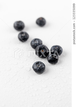 top shot close up on white photo background there are a lot of ripe big blueberries among drops of water healthy vitamins seasonal summer fruits vitamin C forest and bush berries top shot close up on white photo background there are a lot of ripe big blueberries among drops of water healthy vitamins seasonal summer fruits vitamin C forest and bush berries 123335099
