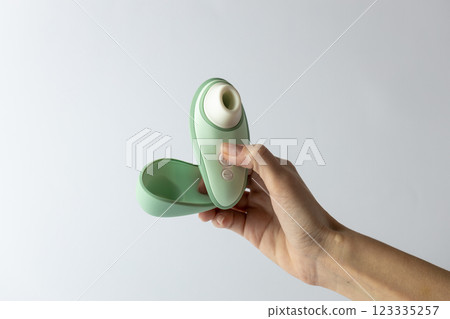 on white background female hands vacuum vibrator and its cover gently mint color device for girls relaxation for adults egg shape magnetic charging water resistance on white background female hands vacuum vibrator and its cover gently mint color device for girls relaxation for adults egg shape magnetic charging water resistance 123335257