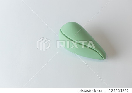 close-up on white background lies closed in the shape of an egg light mint vacuum female vibrator various sex toys moisture-resistant toy modern devices close-up on white background lies closed in the shape of an egg light mint vacuum female vibrator various sex toys moisture-resistant toy modern devices 123335292
