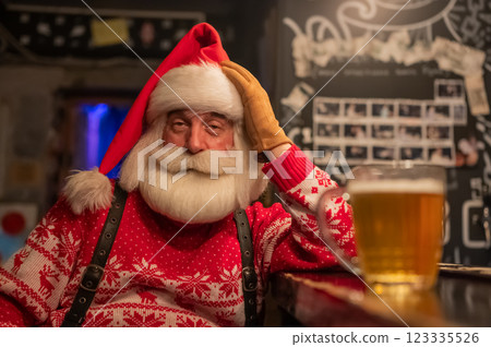 Santa Claus drinking beer at a bar. Santa Claus drinking beer at a bar. 123335526