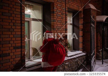 Santa Claus looks out the window. Santa Claus looks out the window. 123335574