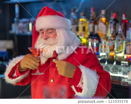 Santa Claus drinking a cocktail at a bar. Santa Claus drinking a cocktail at a bar. 123335578