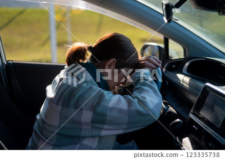 Caucasian woman cries while driving. Caucasian woman cries while driving. 123335738