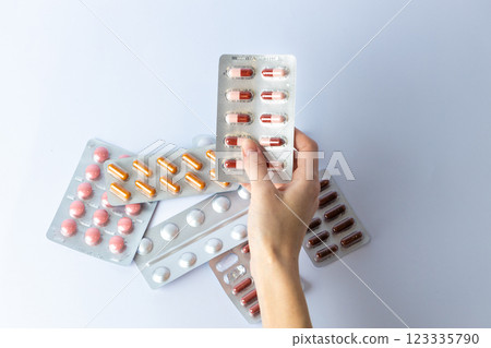 on white background on an outstretched female hand a silver blister with colored capsules suicidal thoughts depression health care pills in the air medical care others on the table on white background on an outstretched female hand a silver blister with colored capsules suicidal thoughts depression health care pills in the air medical care others on the table 123335790