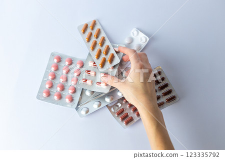on white background on an outstretched female hand a silver blister with colored capsules suicidal thoughts depression health care pills in the air medical care others on the table on white background on an outstretched female hand a silver blister with colored capsules suicidal thoughts depression health care pills in the air medical care others on the table 123335792