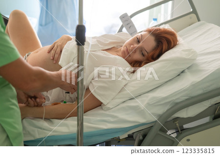 Caucasian woman giving birth in hospital.  123335815