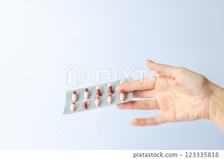 on white background on an outstretched female hand a silver blister with colored capsules suicidal thoughts depression health care pills in the air medical care on white background on an outstretched female hand a silver blister with colored capsules suicidal thoughts depression health care pills in the air medical care 123335818