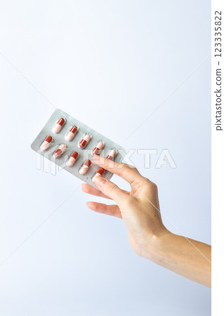 on white background on an outstretched female hand a silver blister with colored capsules suicidal thoughts depression health care pills in the air medical care on white background on an outstretched female hand a silver blister with colored capsules suicidal thoughts depression health care pills in the air medical care 123335822