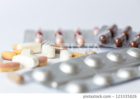 closeup white background on the table there are different silver blisters with colored capsules and tablets suicidal thoughts depression health care medical care vitamins on the table closeup white background on the table there are different silver blisters with colored capsules and tablets suicidal thoughts depression health care medical care vitamins on the table 123335826