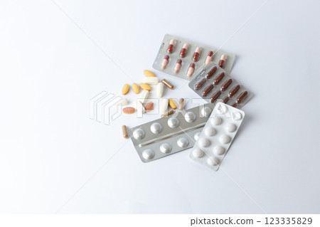 on white background on the table there are different silver blisters with colored capsules and tablets suicidal thoughts depression health care medical care vitamins without packaging on the table on white background on the table there are different silver blisters with colored capsules and tablets suicidal thoughts depression health care medical care vitamins without packaging on the table 123335829