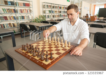 Portrait Caucasian man playing chess.  123335967