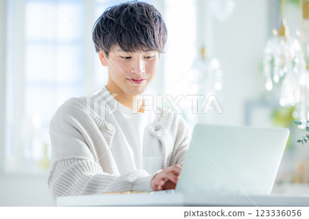 Man thinking while looking at laptop 123336056