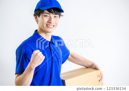 A man wearing work clothes and carrying luggage A man wearing work clothes and carrying luggage 123336134