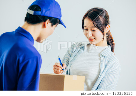 A woman signing a receipt A woman signing a receipt 123336135