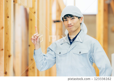 Workers at a wooden building construction site 123336162
