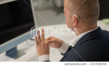 Caucasian deaf man uses sign language for online negotiations. Caucasian deaf man uses sign language for online negotiations. 123336248