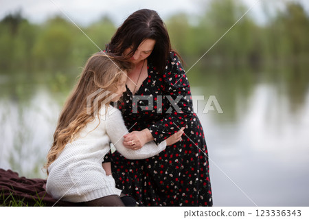 Mom and daughter enjoy a walk in the park on Mother's Day. 123336343