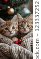 Two playful kittens snuggled together by a festive tree. Generative AI 123337252