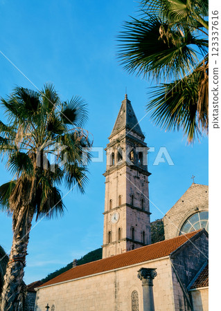 Spire of the bell tower of the Church of St. Nicholas against the blue sky. Perast, Montenegro Spire of the bell tower of the Church of St. Nicholas against the blue sky. Perast, Montenegro 123337616
