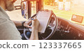 Truck driver sitting in the car and writing documents. 123337665