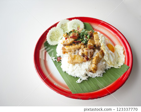 Crispy pork with holy basil and fried egg over rice 123337770