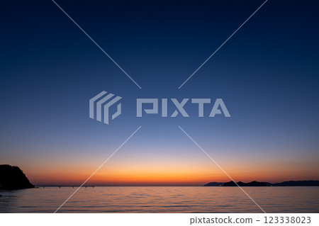 A calm beach after the sun has set over the horizon A calm beach after the sun has set over the horizon 123338023