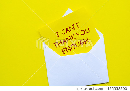 Top view of white envelope with a yellow card partially pulled out with text I Cannot Thank You Enough 123338200