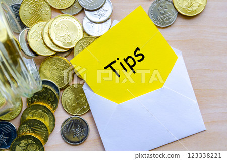 Tips text on yellow paper covered with white envelope. Tips text on yellow paper covered with white envelope. 123338221