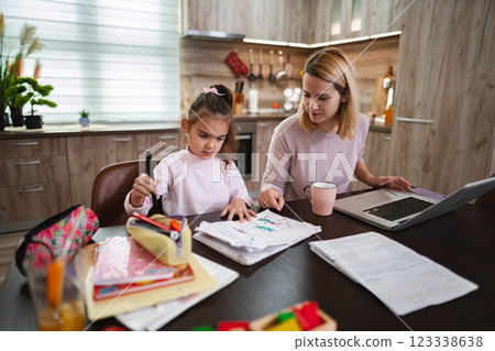 Creative learning moment captured in a cozy kitchen environment 123338638