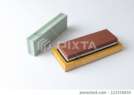 white background on table lies all the equipment a set for sharpening and polishing kitchen knives and various blades different abrasiveness of stones a retainer for knives white background on table lies all the equipment a set for sharpening and polishing kitchen knives and various blades different abrasiveness of stones a retainer for knives 123338830