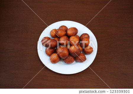 Fried donut holes beignets on wooden background from an African restaurant. International cuisine 123339301
