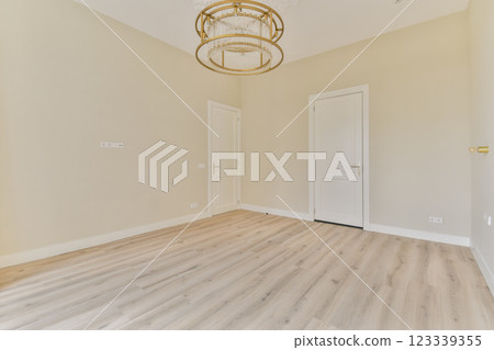 A clean and spacious interior featuring wooden flooring and minimalist design, ideal for various settings and decor styles. Natural light enhances the serene atmosphere. A clean and spacious interior featuring wooden flooring and minimalist design, ideal for various settings and decor styles. Natural light enhances the serene atmosphere. 123339355
