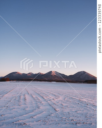 Hokkaido in the harsh winter: View of the Shikaribetsu volcano group from the volcano observation point in Shikaoi Town at dawn Hokkaido in the harsh winter: View of the Shikaribetsu volcano group from the volcano observation point in Shikaoi Town at dawn 123339748