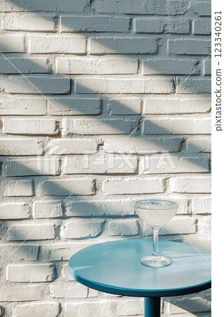 Vodka cocktail on blue wooden table and white brick background 123340261
