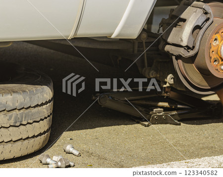 Car in service repairing. Detail of wheel assembly on automobile 123340582